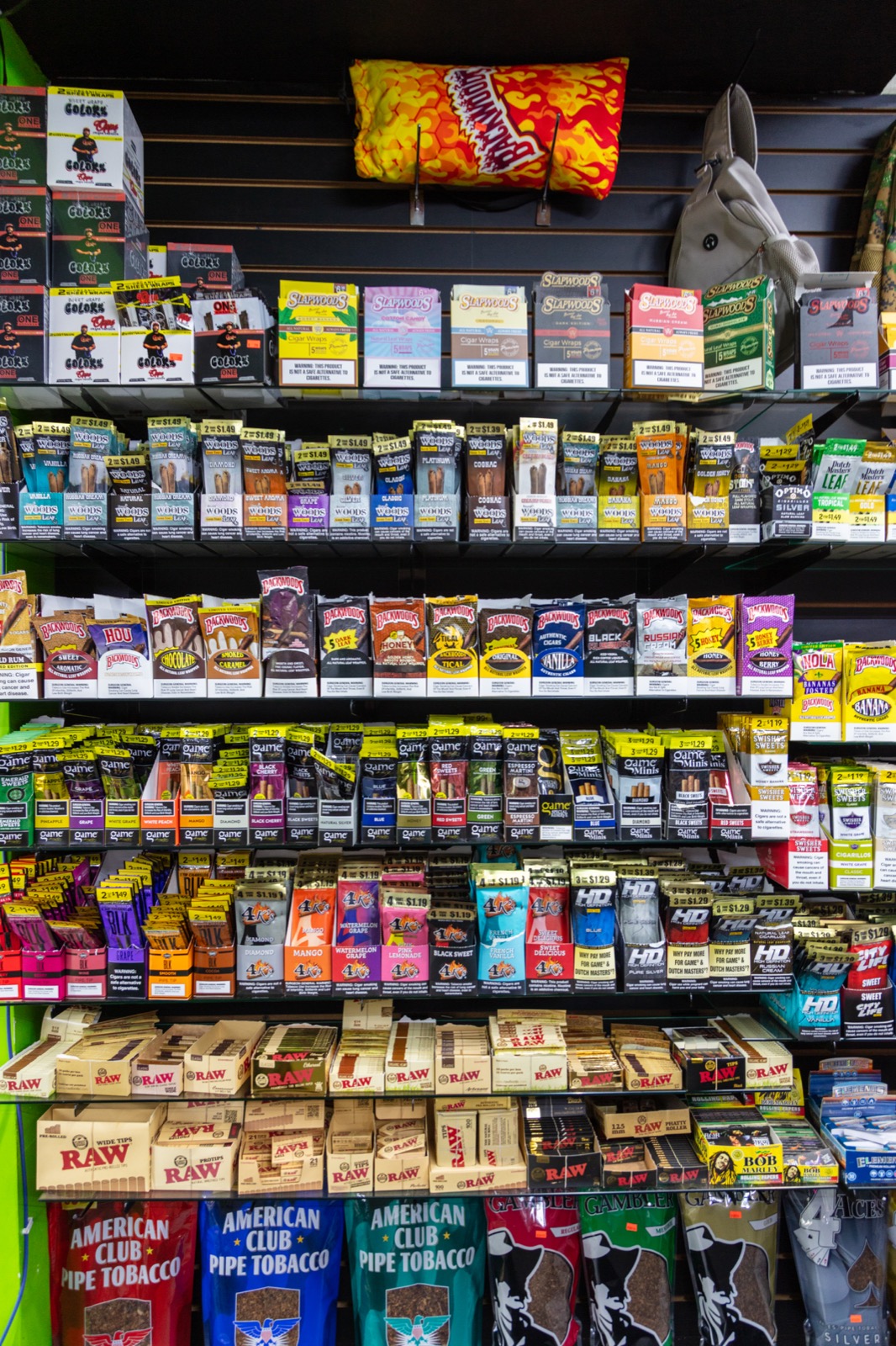 Rolling papers and cigar wrap merchandising wall with RAW and Backwoods